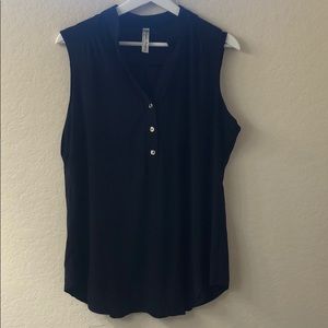 Black sleeveless blouse with gold buttons